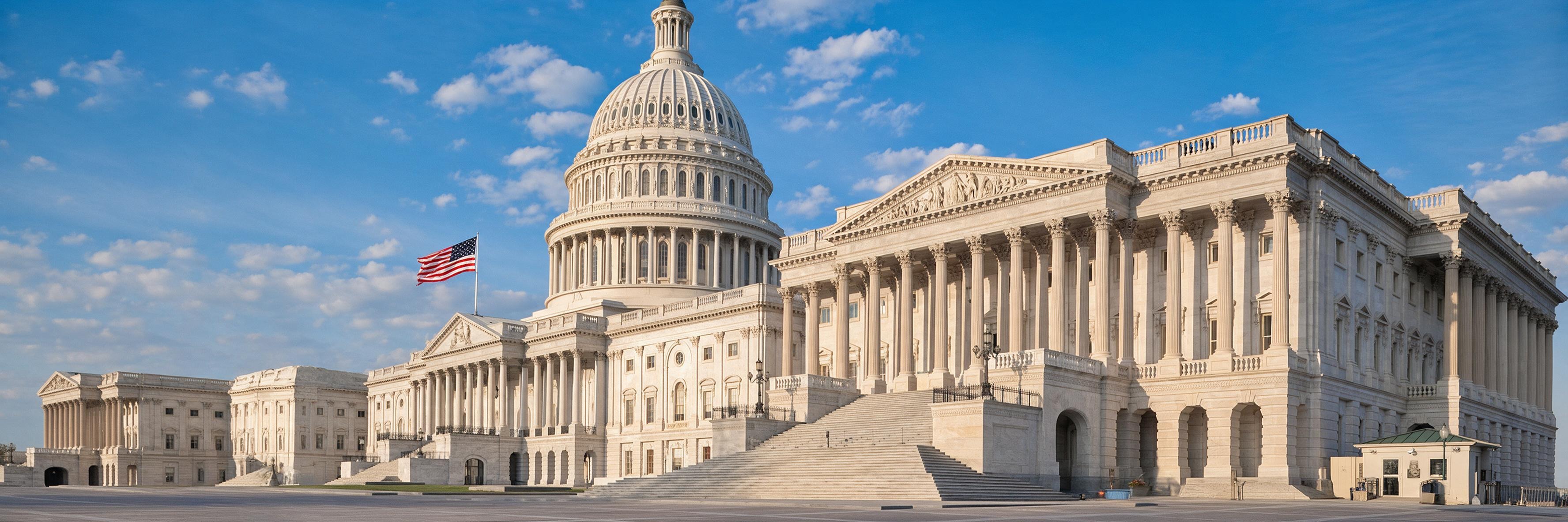 The United States Capitol beneath an open blue sky